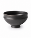 Handmade black ceramic serving bowl with textured finish and footed base