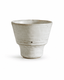Handmade speckled white stoneware yunomi tea cup with a handleless footed design and irregular rim