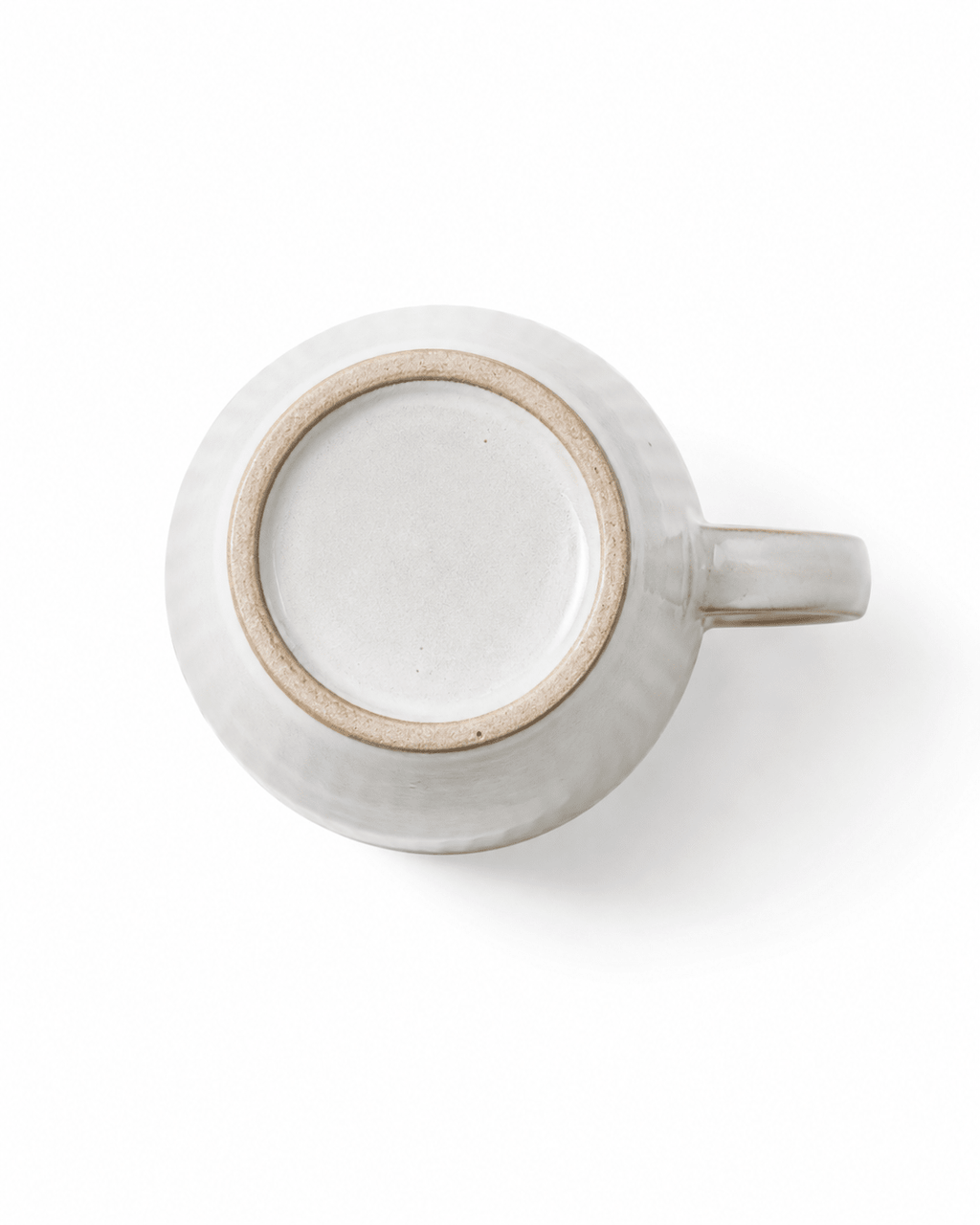 Bottom view of 300ml ivory white handmade ceramic mug showing natural ceramic foot ring and handle