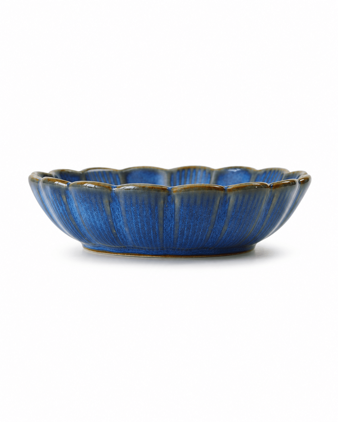 Side view of blue glazed ceramic dipping dish with scalloped rim and textured handcrafted finish Main image