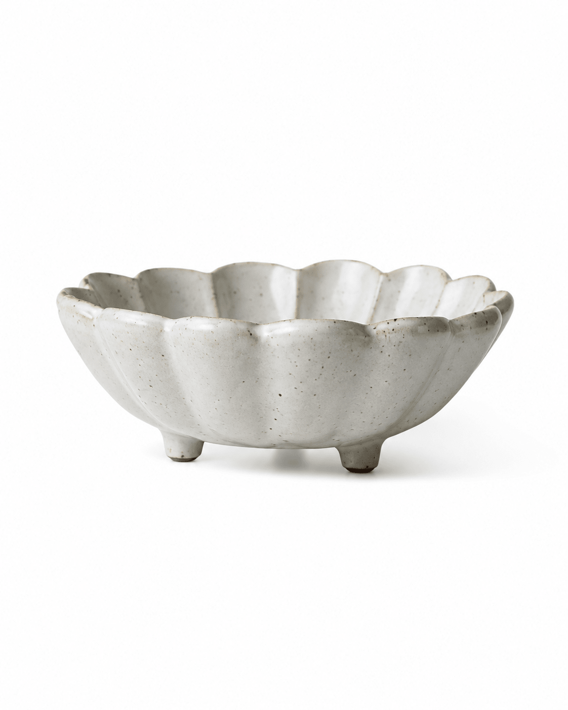 Side view of handmade white speckled footed ceramic flower bowl with scalloped rim Main image