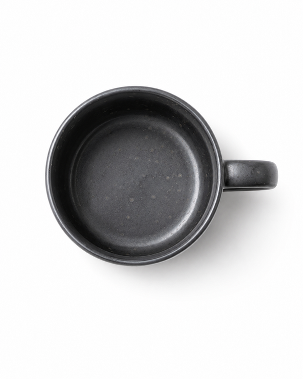 Top view of a handmade black stoneware coffee mug showing the matte speckled ceramic interior
