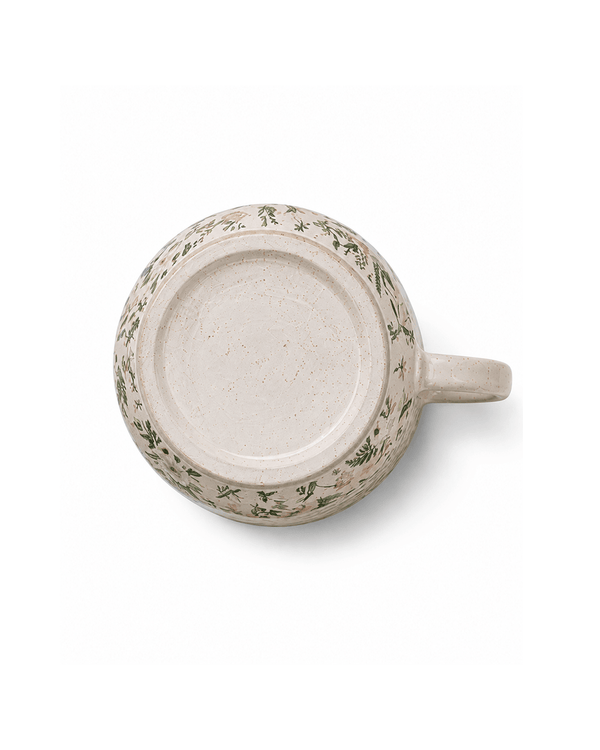 Bottom view of botanical ceramic mug showing the speckled ceramic base and foot ring