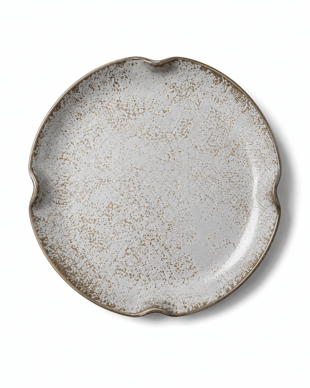 Top view of grey white speckled reactive glaze ceramic plate with brown detailing and four-point irregular rim