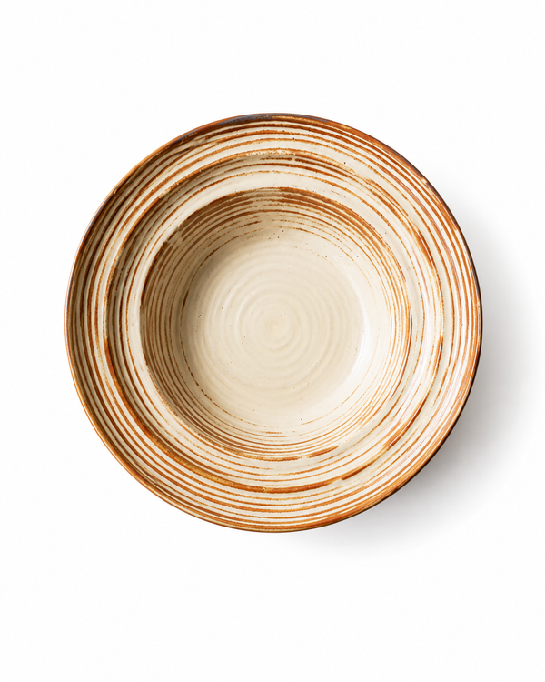 Top view of handmade beige and brown striped ceramic pasta bowl with reactive glaze, wide rim and concentric line detailing