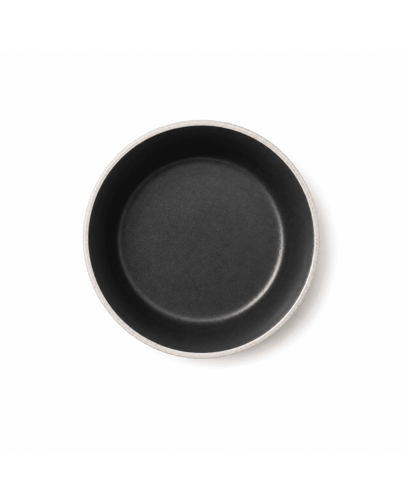 Top view of handmade ceramic bowl with matte black interior and speckled grey rim