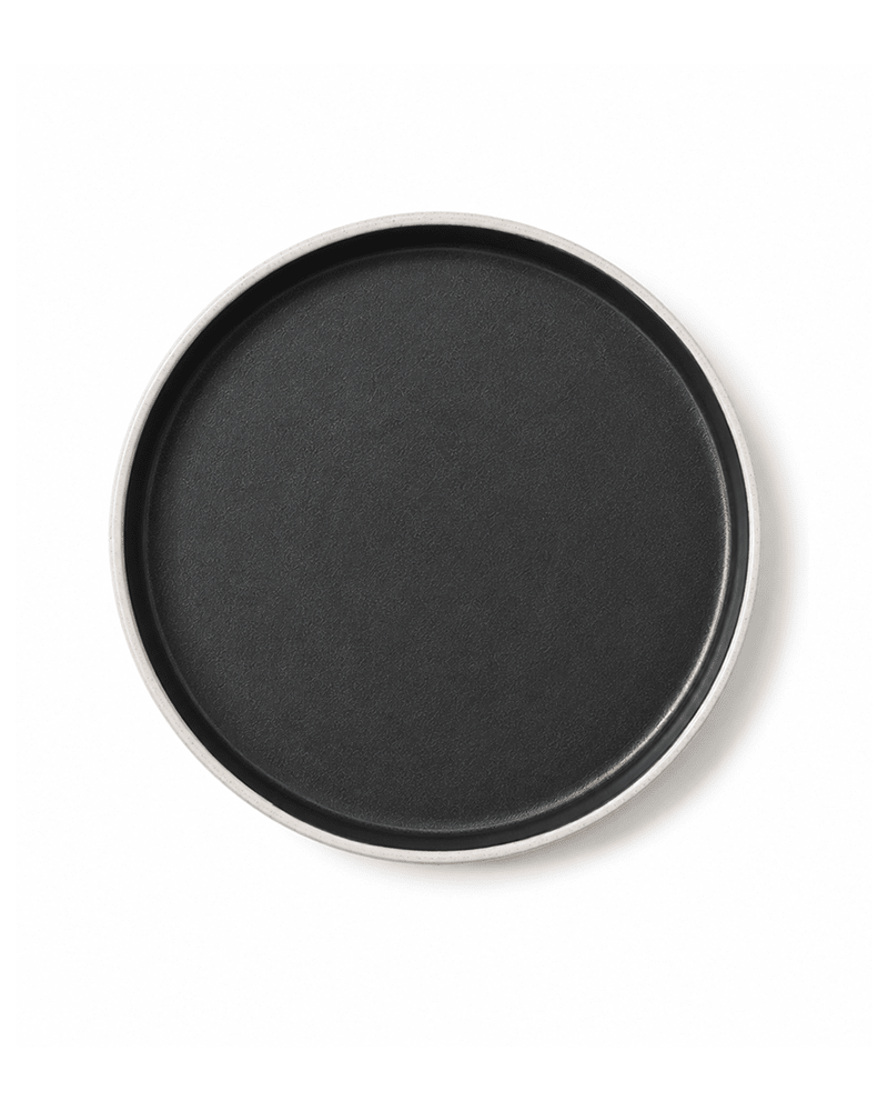 Top view of handmade ceramic side plate with matte black interior and speckled grey rim