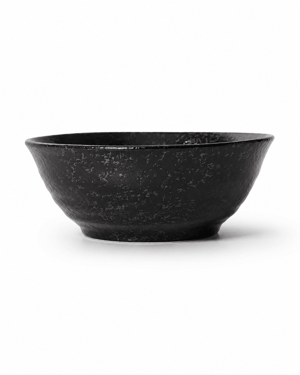 Side view of handmade black reactive glaze stoneware bowl with flared rim, textured fini