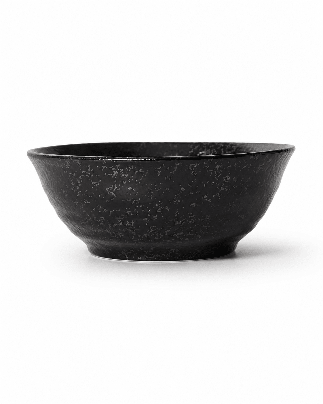Side view of handmade black reactive glaze stoneware bowl with flared rim, textured fini