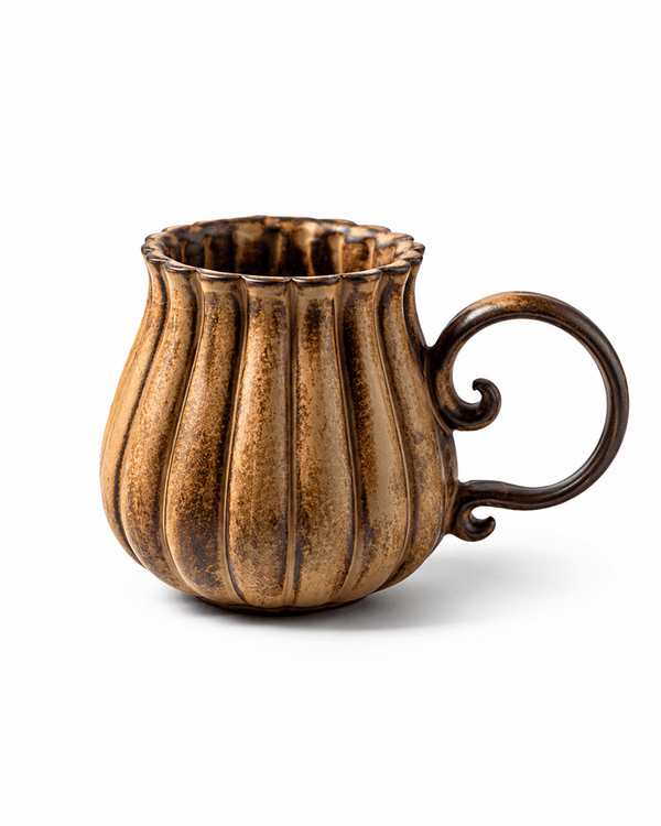 Handmade brown ribbed stoneware coffee mug with reactive glaze and decorative curled handle