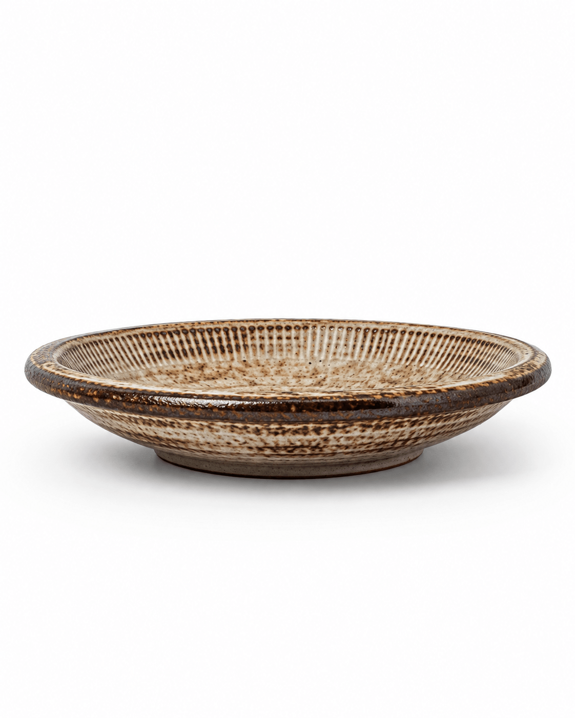 Side view of handmade brown speckled reactive glaze ceramic pasta bowl with a wide shallow profile and dark glazed rim