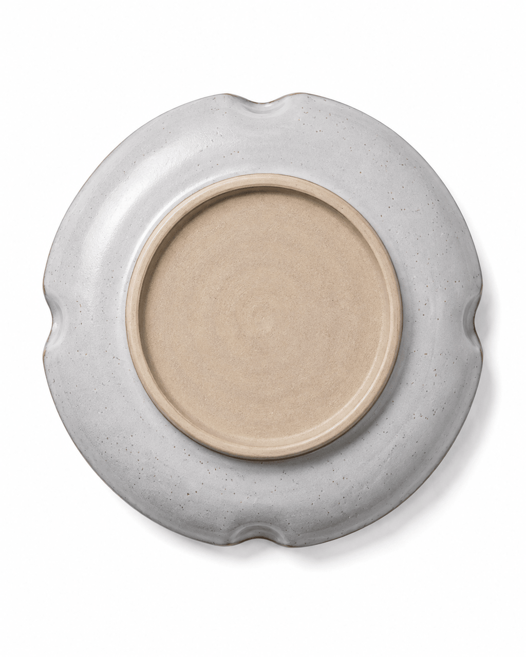 Bottom view of handmade ceramic dinner plate showing the circular unglazed foot ring and grey white glazed exterior