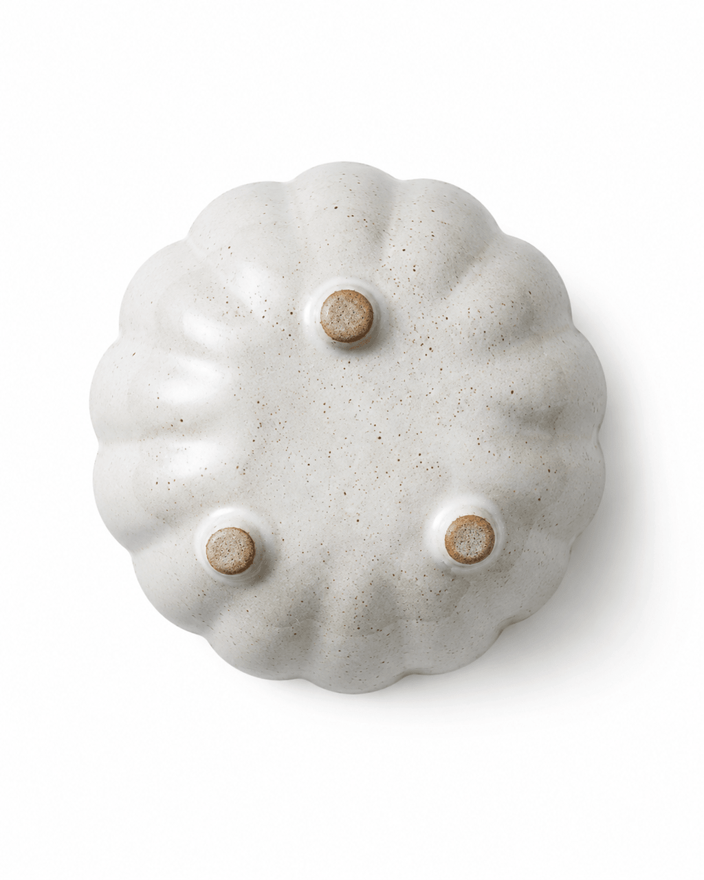 Bottom view of handmade white speckled ceramic flower bowl with three raised feet