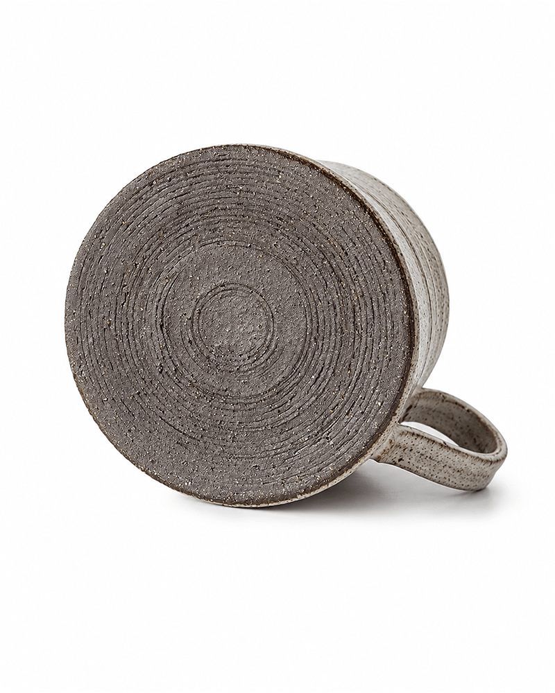 Handmade ceramic mug with textured wheel-thrown base