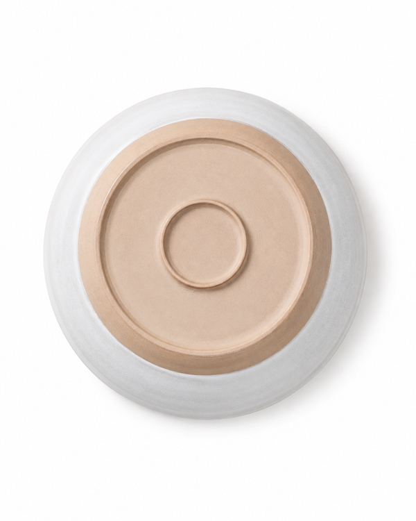 Bottom view of handmade ceramic pasta bowl showing the natural clay base and circular foot ring