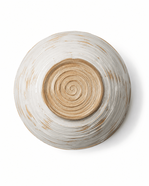 Bottom view of a handmade ceramic serving bowl showing the natural clay base and concentric pottery wheel marks