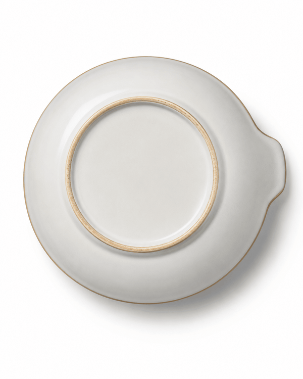 Bottom view of large handmade ceramic serving bowl showing the foot ring, ivory glaze and integrated handle