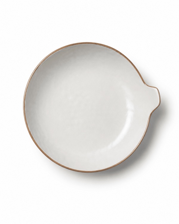 Top view of large handmade ceramic serving bowl with handle, ivory reactive glaze and warm brown rim