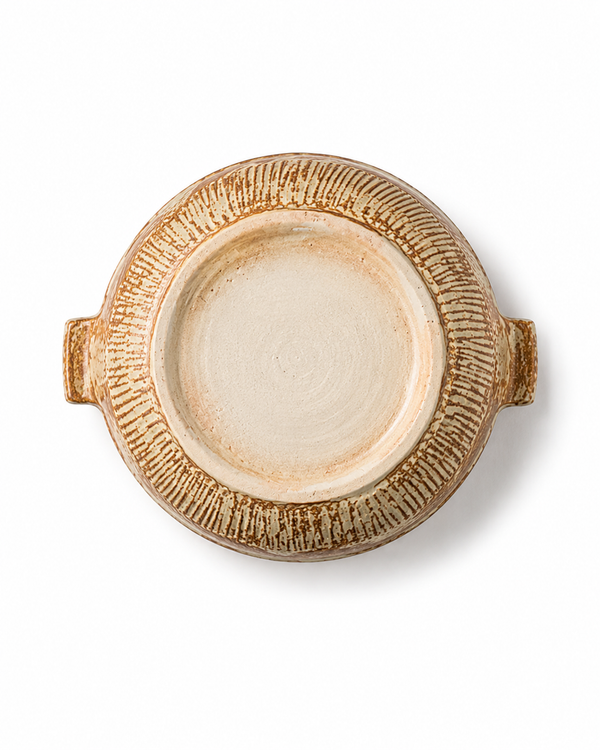 Bottom view of a handmade ceramic serving platter showing the unglazed foot, textured pottery surface and two handles