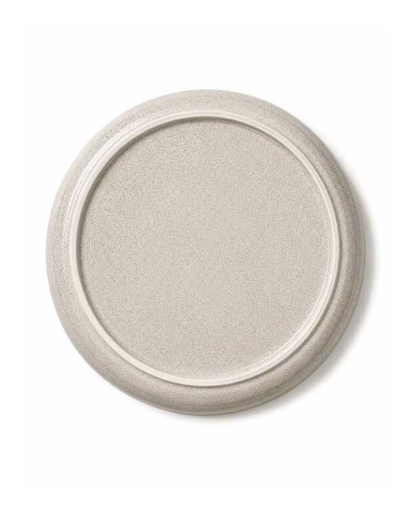 Bottom view of handmade grey ceramic dinner plate with speckled glaze and raised foot ring