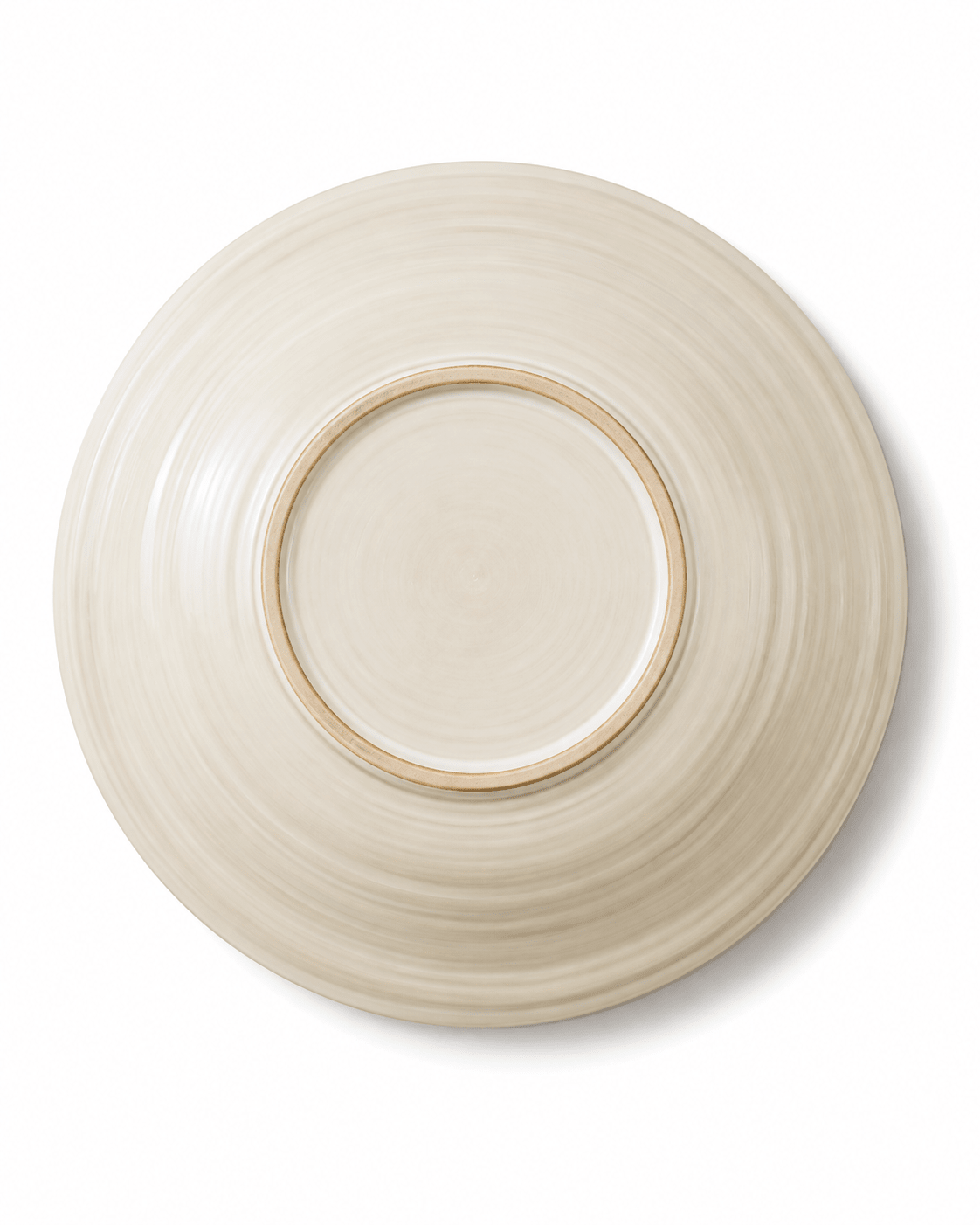 Base view of a handmade ivory stoneware pasta bowl showing the ceramic foot ring and textured glaze finish
