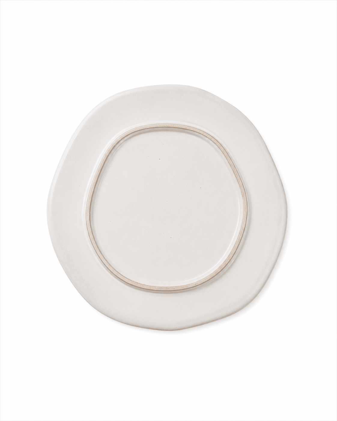 Bottom view of handmade ivory white ceramic dinner plate showing the raised foot ring