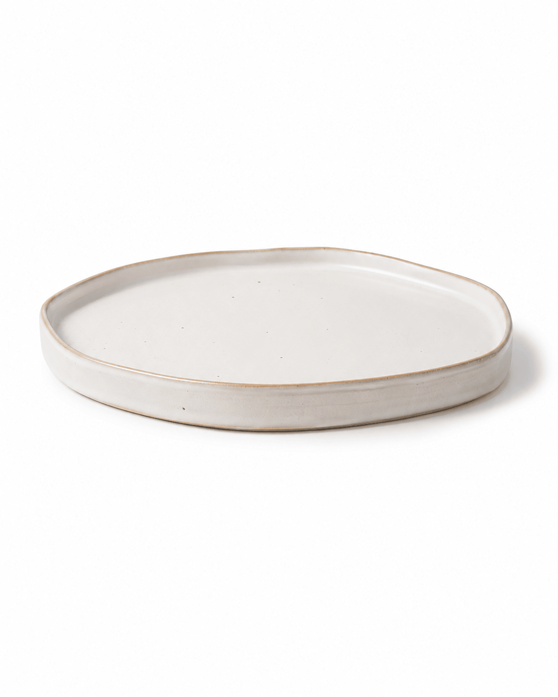 Side view of handmade ivory white ceramic dinner plate with raised irregular rim Main image