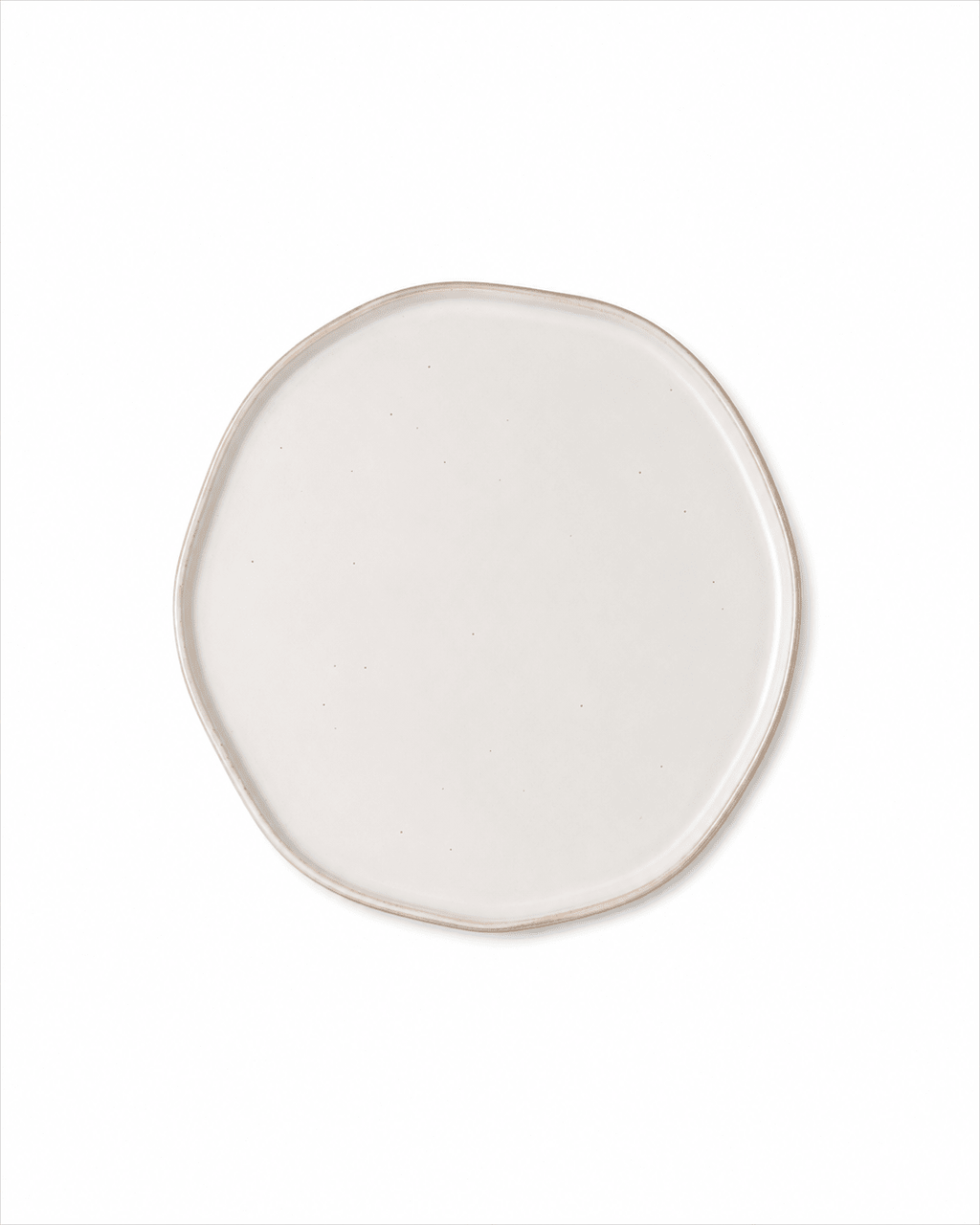 Top view of handmade ivory white ceramic dinner plate with organic irregular shape and subtle speckled glaze
