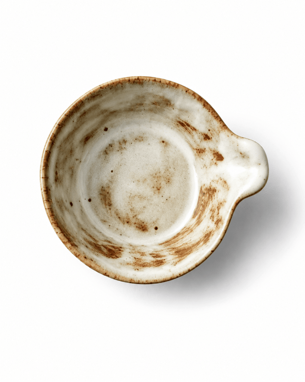 Top view of handmade Japanese style ceramic sauce dish with small handle