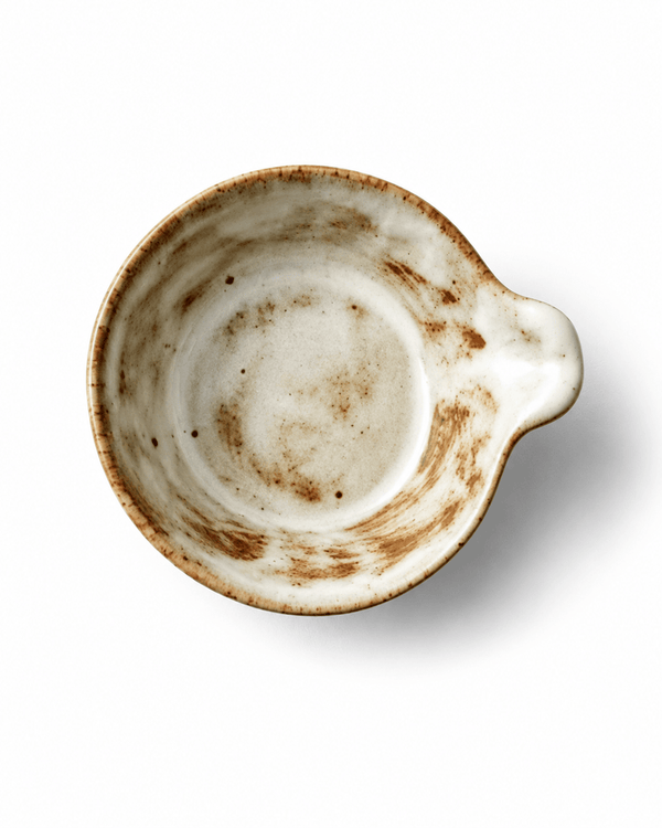 Top view of handmade Japanese style ceramic sauce dish with small handle
