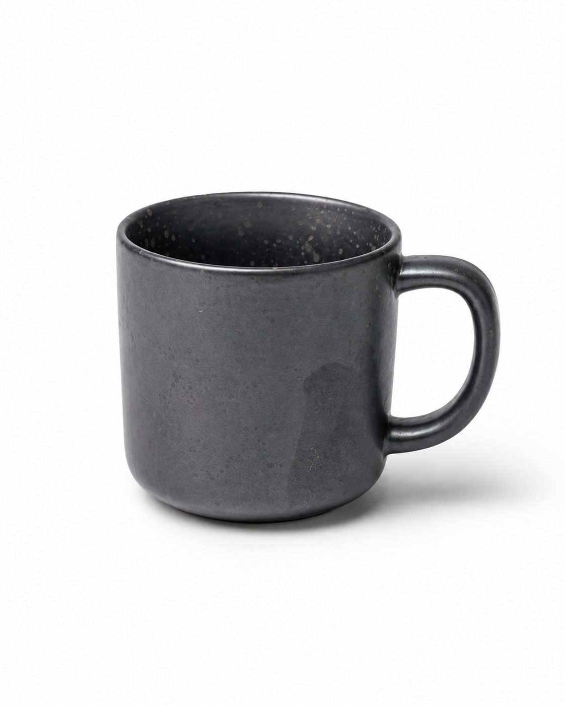 Handmade matte black stoneware coffee mug with subtle speckled glaze and rounded handle Main image