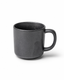 Handmade matte black stoneware coffee mug with subtle speckled glaze and rounded handle