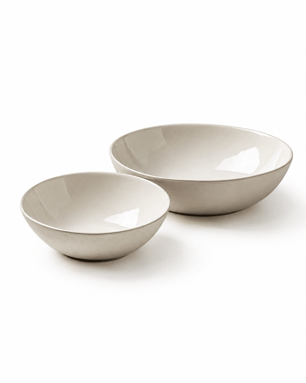 Side view of handmade off white ceramic pasta and cereal bowl set with softly rounded sides and natural textured finish