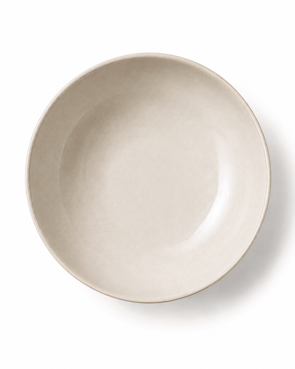 Top view of a handmade off-white ceramic large bowl with a softly irregular rim and natural glazed finish