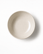 Top view of a handmade off-white ceramic small bowl with a softly irregular rim and natural glazed finish