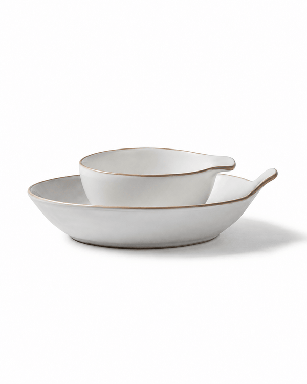 Side view of handmade reactive glaze ceramic serving bowl set with ivory finish, brown rims and handles