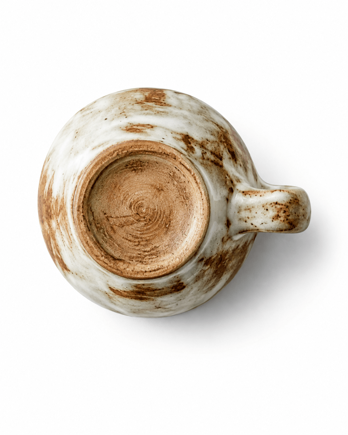 Bottom view of handmade rustic ceramic sauce dish showing the natural unglazed foot