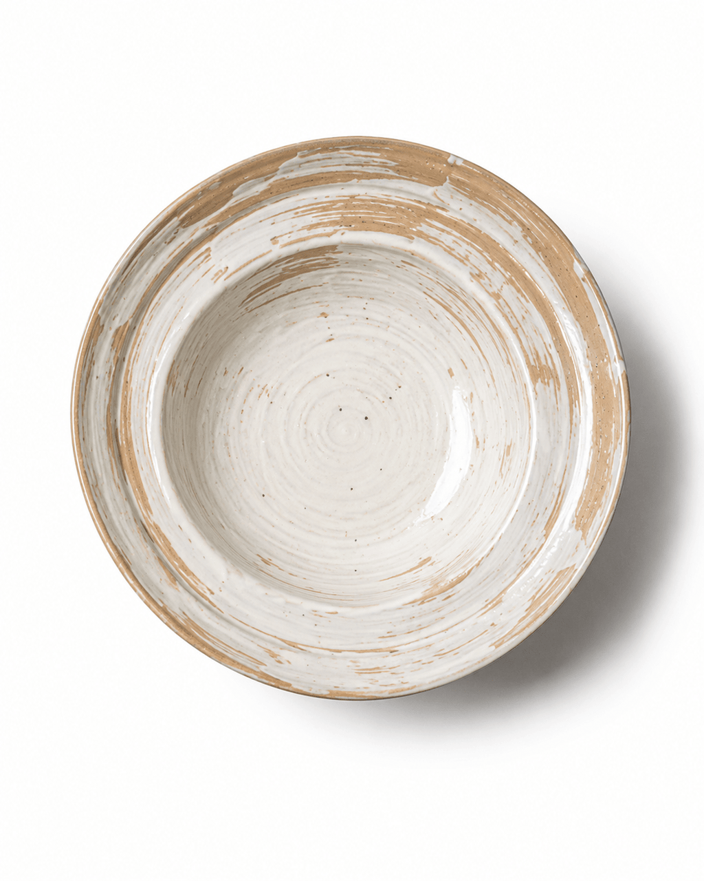 Top view of a handmade rustic ceramic serving bowl with white and beige brushed glaze and natural pottery texture
