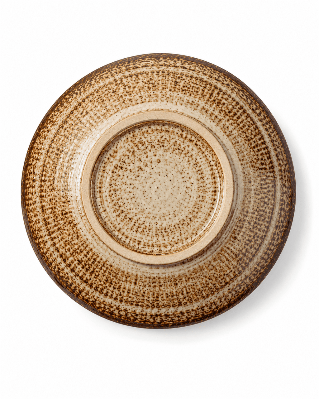 Bottom view of handmade speckled ceramic pasta bowl showing the circular foot ring and natural brown reactive glaze pattern