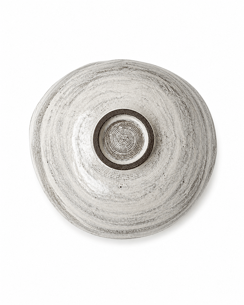 Base view of handmade speckled ceramic serving bowl showing circular foot and natural glaze texture