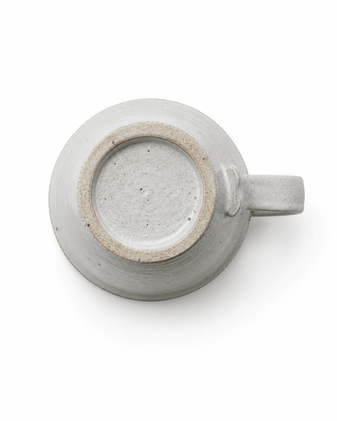 Bottom view of handmade speckled stoneware mug showing the raised footed base and natural ceramic texture