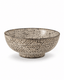 Side view of handmade speckled stoneware serving bowl with carved geometric pattern and rustic dark rim