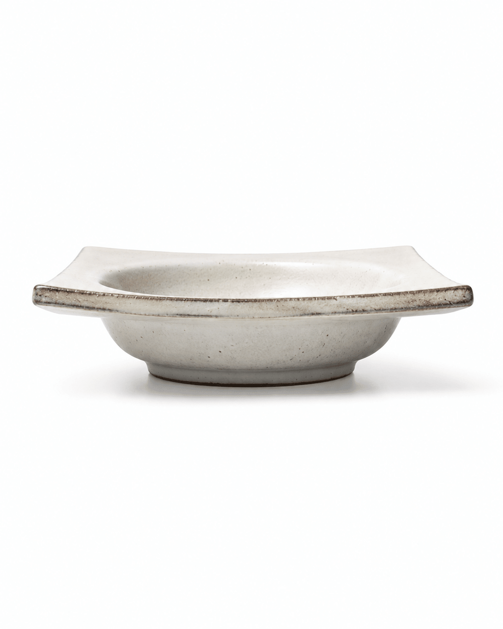 Side view of handmade square ceramic dipping bowl with raised edges and shallow centre