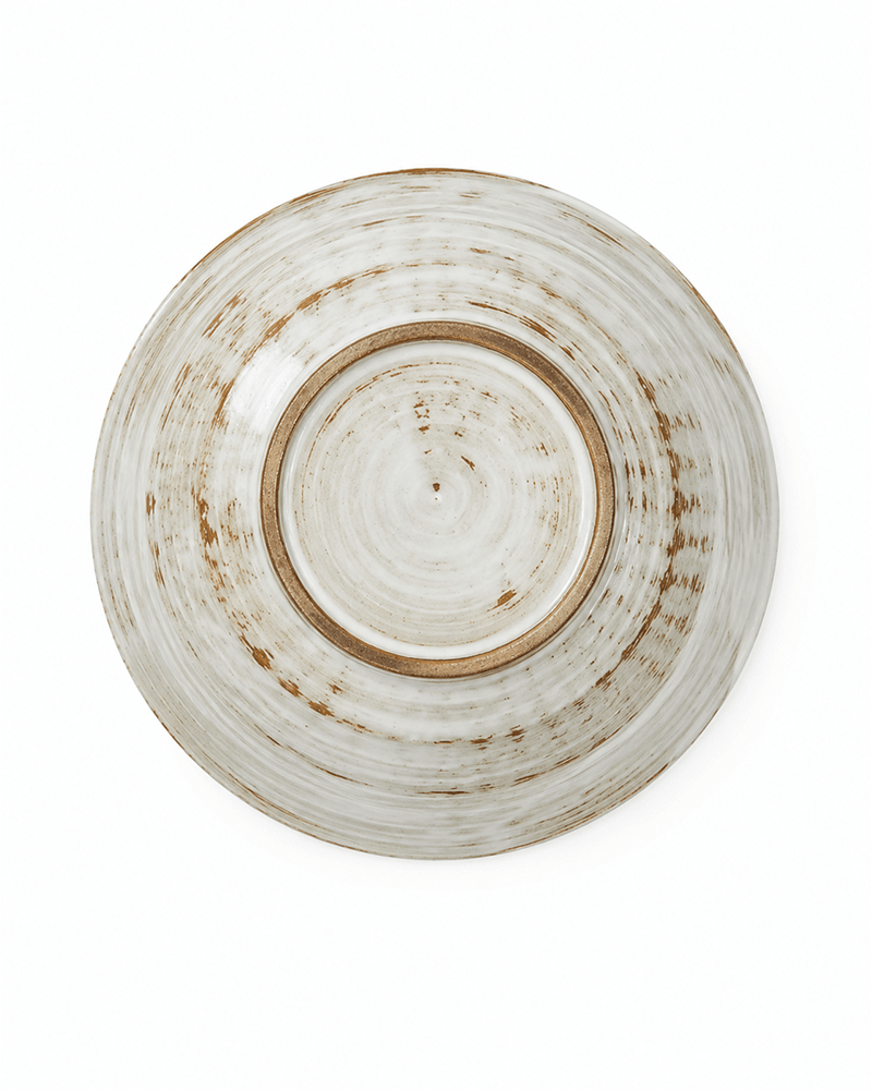 Bottom view of handmade white and brown stoneware bowl showing the natural foot ring and glaze variation, 7.2 inch