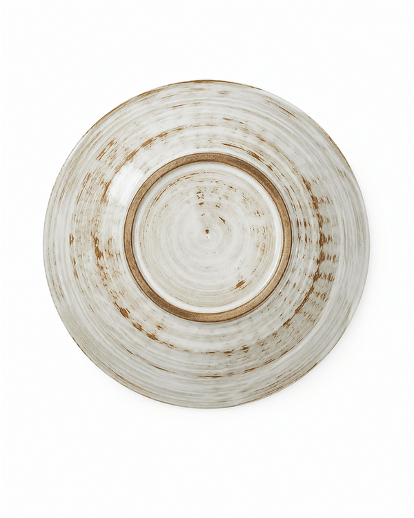 Bottom view of handmade white and brown stoneware bowl showing the natural foot ring and glaze variation, 7.2 inch