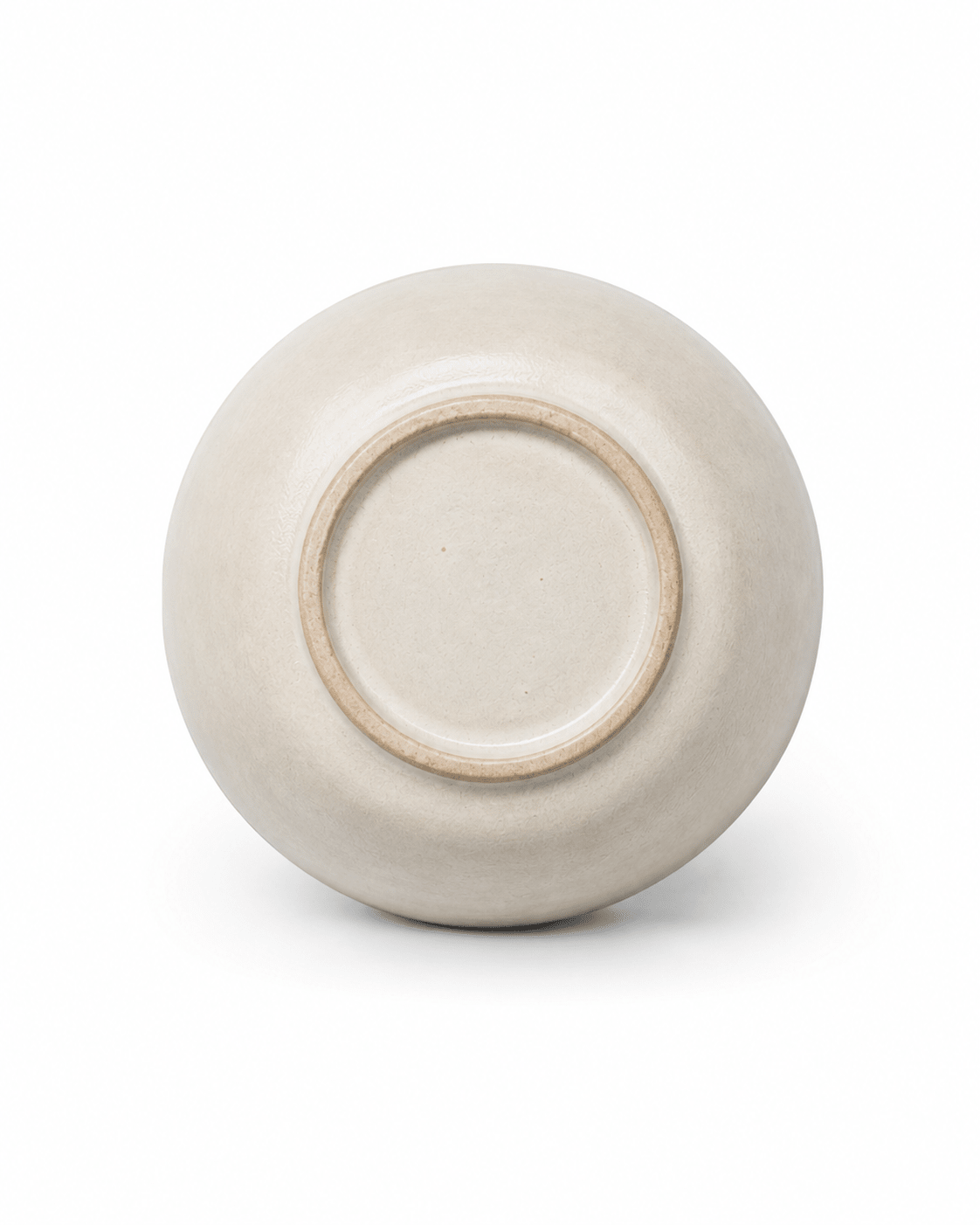 Base detail of handmade off-white stoneware tea cup showing the natural ceramic finish