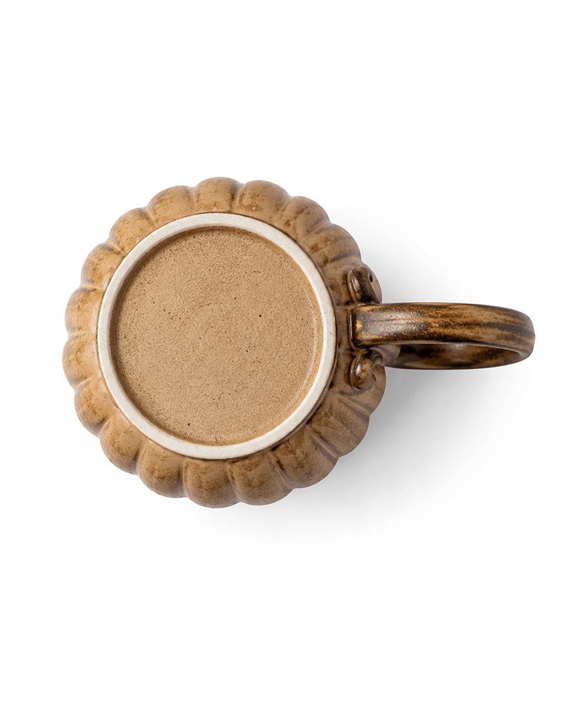 Bottom view of handmade stoneware mug showing unglazed ceramic foot and natural handcrafted texture
