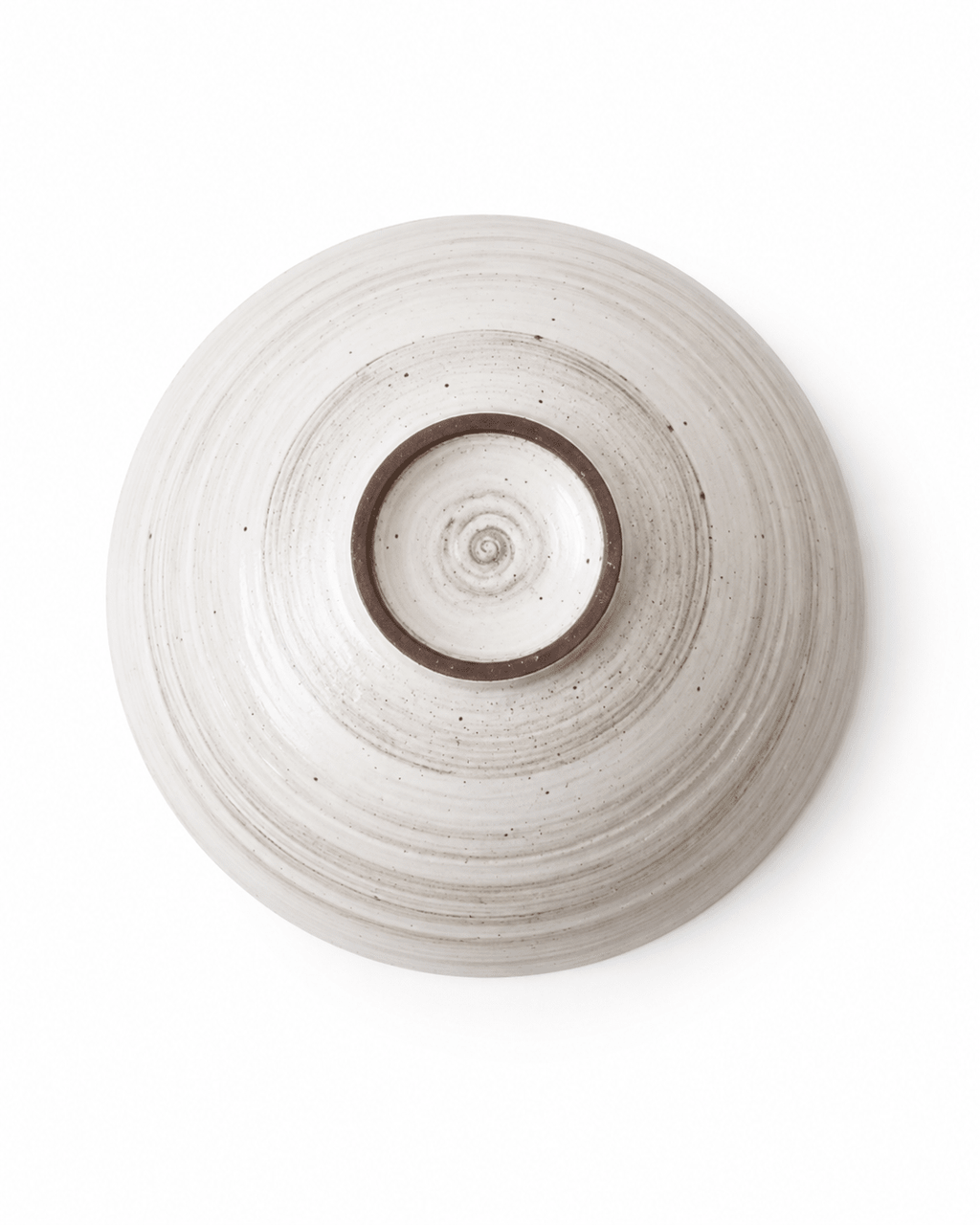 Bottom view of handmade speckled stoneware serving bowl showing foot ring and wheel-thrown texture