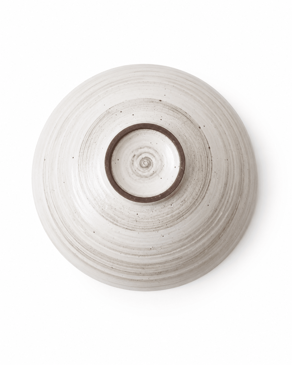 Bottom view of handmade speckled stoneware serving bowl showing foot ring and wheel-thrown texture