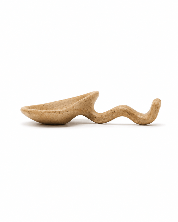 Side view of handmade speckled stoneware soy sauce dish showing the raised curved chopstick rest